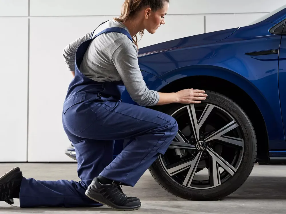 A technician fitting a wheel at Autohaus Namibia